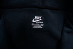 Nike track jacket in black featuring an embroidered swoosh logo on the chest, size label