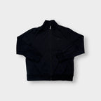 Nike track jacket in black featuring an embroidered swoosh logo on the chest