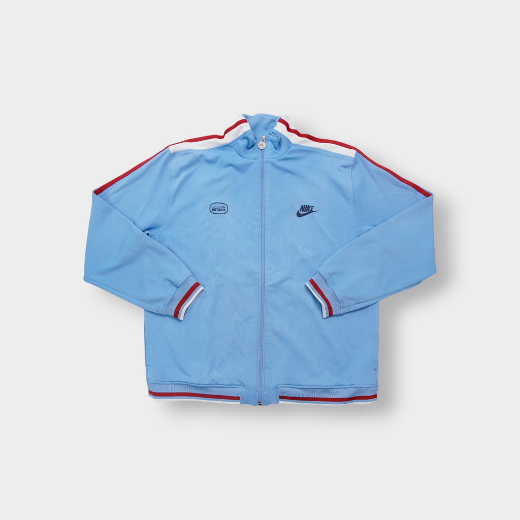 Light blue Nike jacket with red shoulder stripes and embroidered chest logo