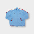 Light blue Nike jacket with red shoulder stripes and embroidered chest logo