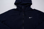 Nike zip hoodie in dark blue with embroidered white Swoosh logo on chest, detail