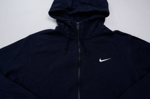 Nike zip hoodie in dark blue with embroidered white Swoosh logo on chest, detail