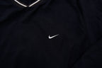 Nike Golf sweater in black with a V-neck collar and a small white embroidered swoosh, detail