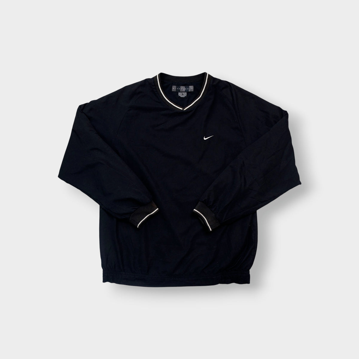 Nike Golf sweater in black with a V-neck collar and a small white embroidered swoosh