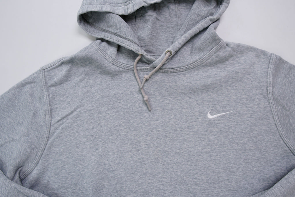 Nike grey hoodie sweater featuring a small white embroidered Swoosh logo on the chest, full view