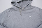 Nike grey hoodie sweater featuring a small white embroidered Swoosh logo on the chest, full view