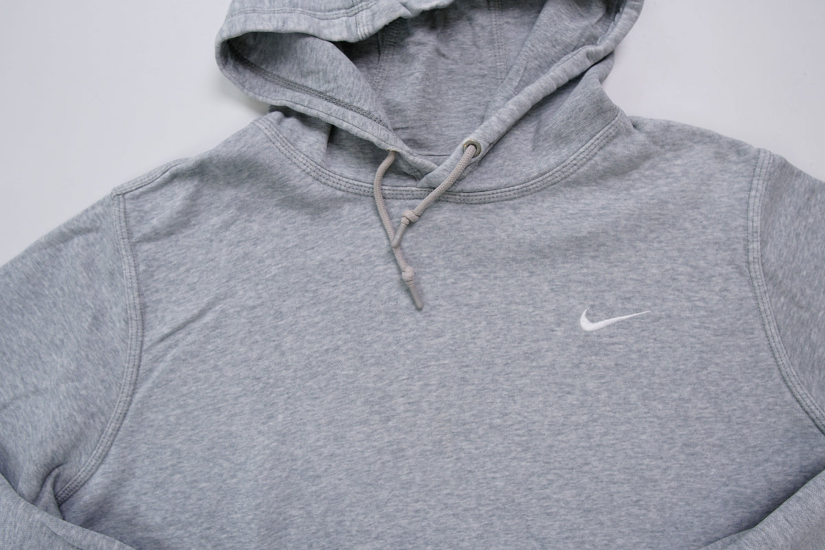 Nike grey hoodie sweater featuring a small white embroidered Swoosh logo on the chest, full view