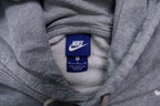 Nike grey hoodie sweater featuring a small white embroidered Swoosh logo on the chest, size label
