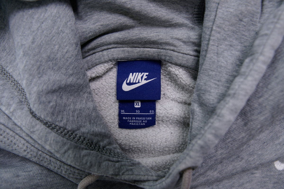 Nike grey hoodie sweater featuring a small white embroidered Swoosh logo on the chest, size label