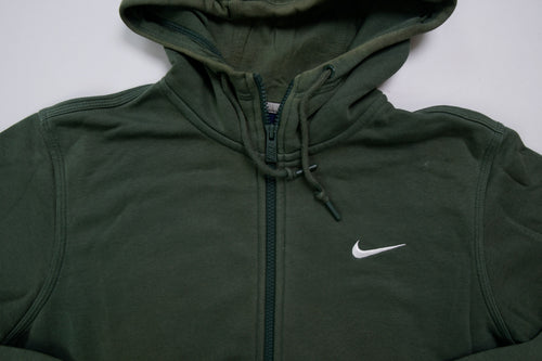 Nike sweater in green featuring an embroidered white Swoosh logo on the chest, detail