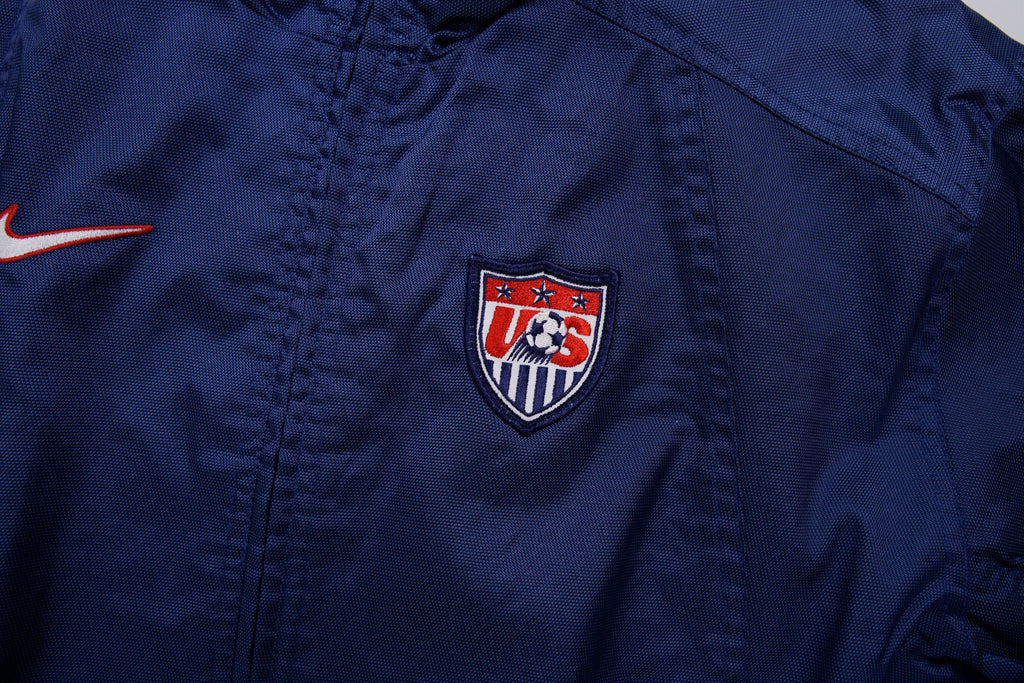 Nike track jacket in navy blue featuring an embroidered US Soccer crest, detail