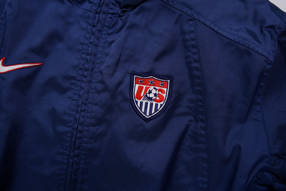 Nike track jacket in navy blue featuring an embroidered US Soccer crest, detail