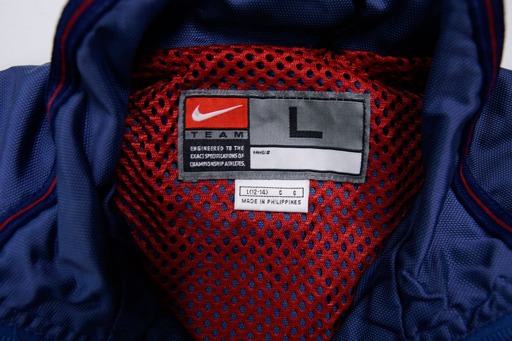 Nike track jacket in navy blue featuring an embroidered US Soccer crest, size label
