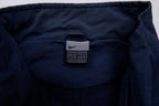 Nike jacket in navy featuring an embroidered orange Swoosh on the chest, size label