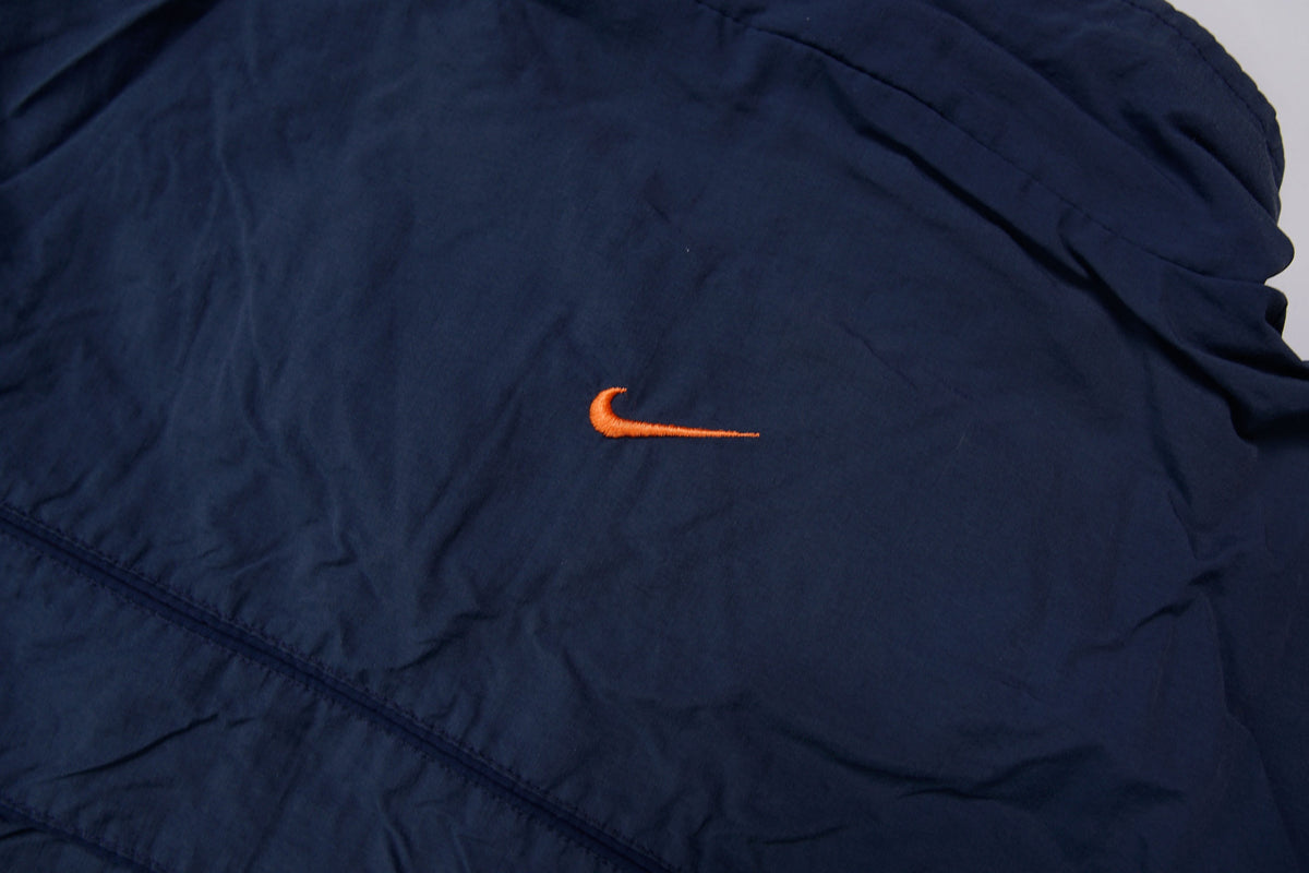 Nike jacket in navy featuring an embroidered orange Swoosh on the chest, detail 3