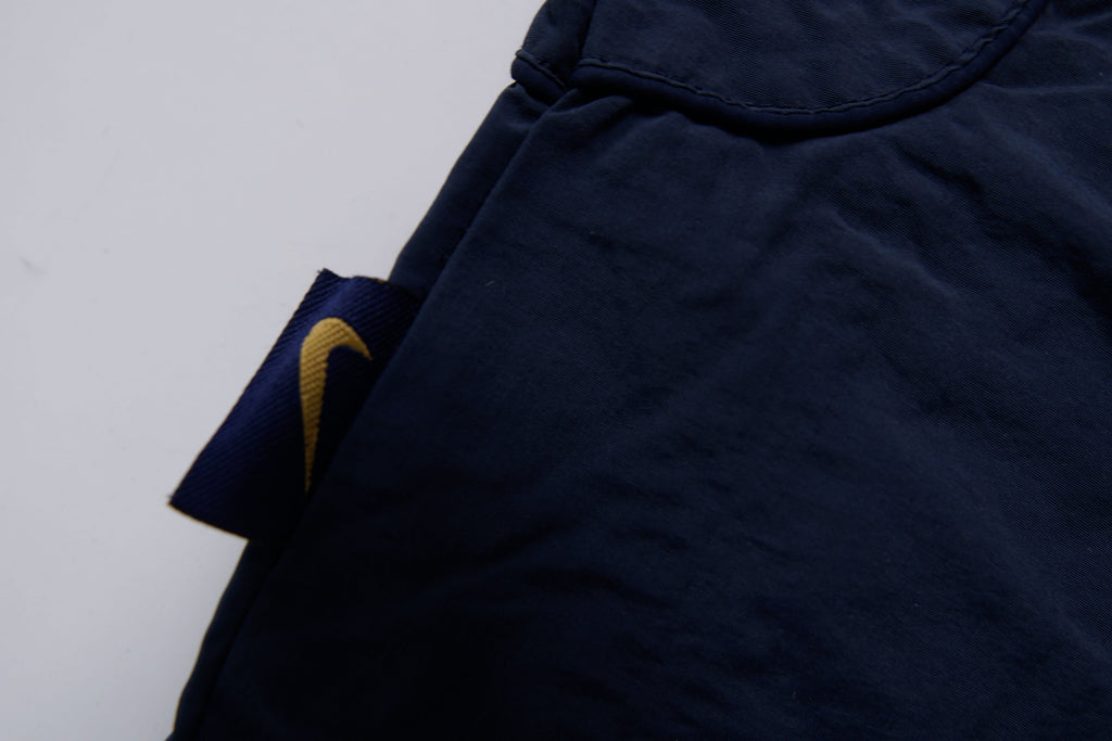 Nike jacket in navy featuring an embroidered orange Swoosh on the chest, detail 4