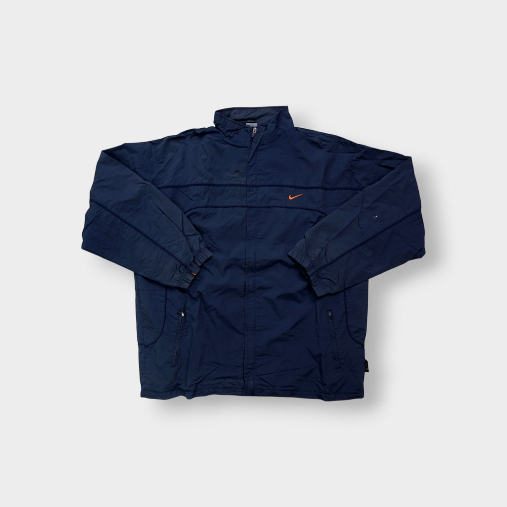 Nike jacket in navy featuring an embroidered orange Swoosh on the chest