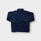 Nike jacket in navy featuring an embroidered orange Swoosh on the chest