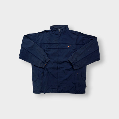 Nike jacket in navy featuring an embroidered orange Swoosh on the chest