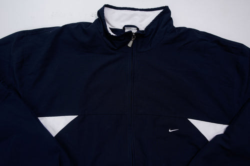 Nike zip-up track jacket in navy with red side panels and a small white swoosh logo, full view