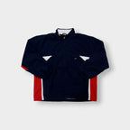 Nike zip-up track jacket in navy with red side panels and a small white swoosh logo