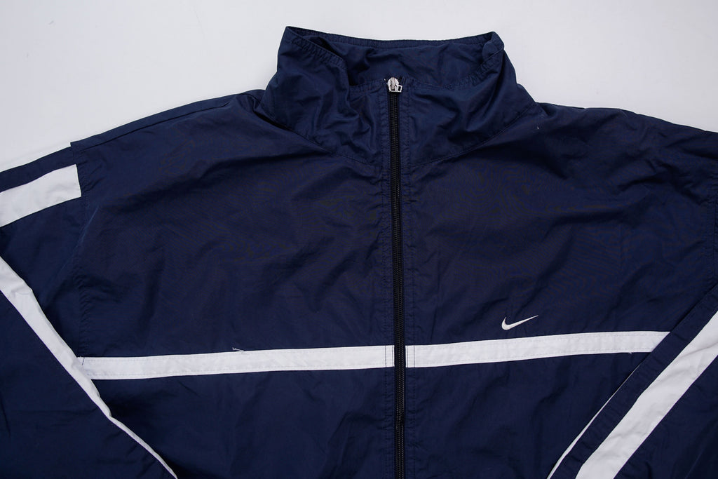 Navy Nike zip-up jacket with white contrast stripes across the chest and sleeves, full view