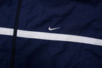 Navy Nike zip-up jacket with white contrast stripes across the chest and sleeves, detail