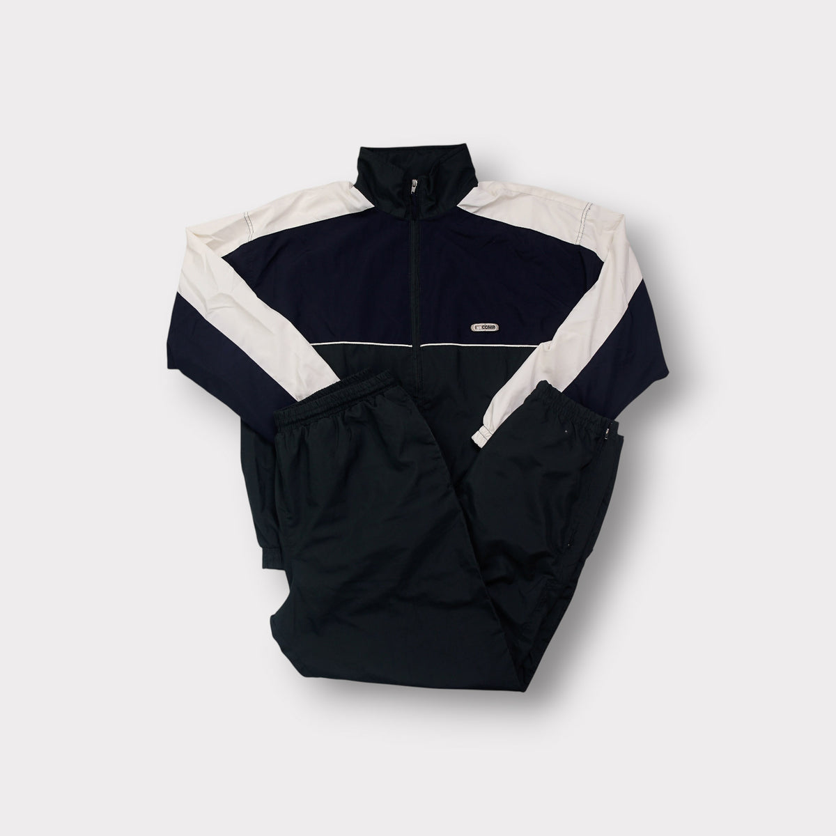 Crane tracksuit in black and white featuring a full-zip top and chest patch