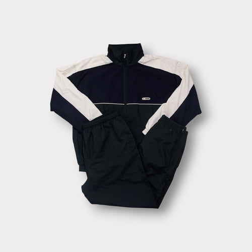 Crane tracksuit in black and white featuring a full-zip top and chest patch