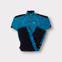 Lade das Bild in den Galerie-Viewer, Puma tracksuit in blue and black with a white embroidered cat logo on the chest.